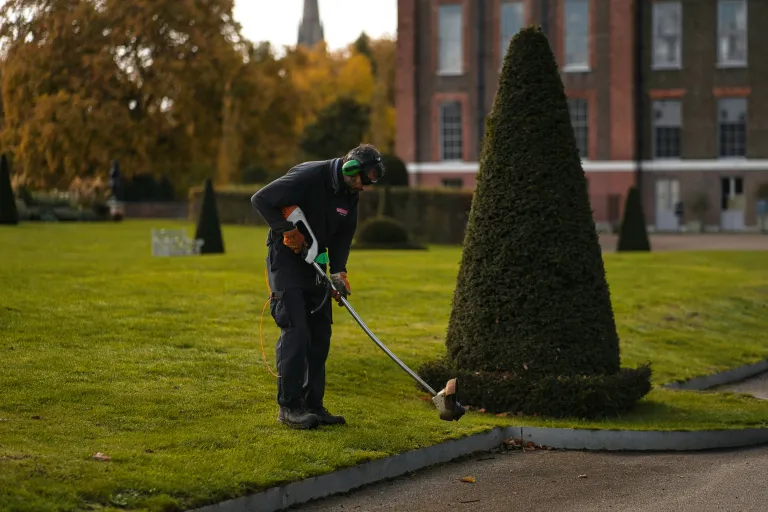 Landscaper performing fall cleanup with leaf blower